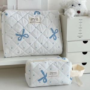 Quilted blue polka dot cosmetic bag set with bow pattern and zip closure for travel