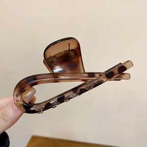 Close-up of a large leopard print hair claw clip in brown tortoiseshell finish