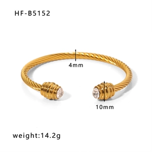 Detail of gold twisted cable cuff bracelet with crystal ends and 4mm width measurements