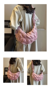 Close-up of pink quilted puffer hobo bag with cloud texture and zip closure