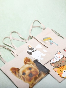 Cute canvas tote bag featuring dog and cat cartoon prints with minimalist shoulder straps
