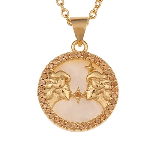 Macro detail of gold Gemini pendant with mother of pearl and crystal encrusted edge
