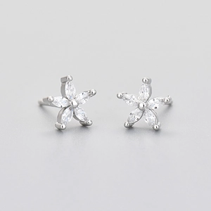 Macro shot of silver flower stud earrings with clear sparkling zircon petals