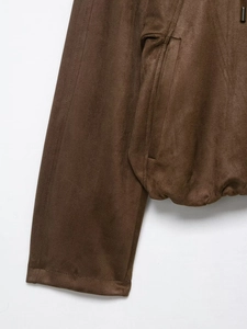 Detail of brown faux suede jacket showing pocket stitching and cuff texture