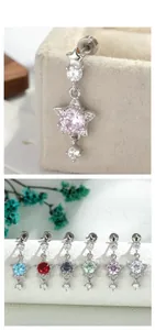 Macro detail of star-shaped cartilage studs featuring colorful zircon inlay and screw-back