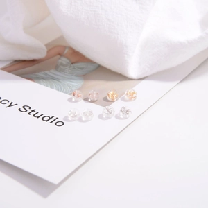 Detailed view of clear silicone and gold S925 silver earring backs on a display card