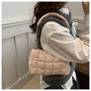 Detail of pink quilted shoulder bag with fluffy embroidery and gold chain strap