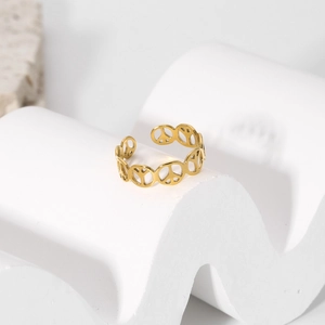 Detail of gold hollow peace sign ring with adjustable open band on a white stand