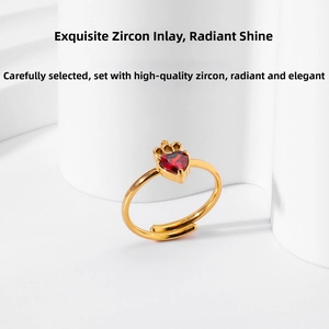 Detail of gold crown ring with red heart zircon and adjustable open band design