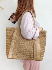 Large hand-woven straw tote bag with side fringe for beach vacation and daily use