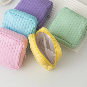 Detailed view of five colorful quilted PU pouches with top zipper and inner pocket