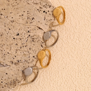Detail of 18K gold and silver plated signet rings with custom engraved LTS text