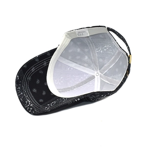 Detail of the black paisley baseball cap interior showing the sweatband and care label