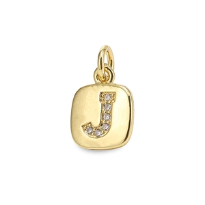 Macro detail of gold plated square pendant with inlaid zircon letter J and bail ring