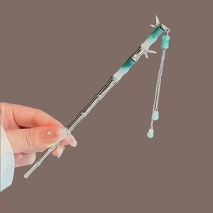 Detailed view of silver bamboo tassel hairpin with green gradient floral accents