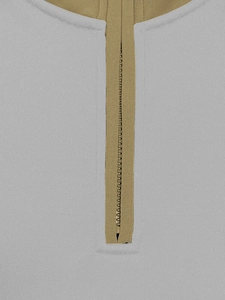 Detail view of the gray knit fabric texture and khaki half-zip collar stitching