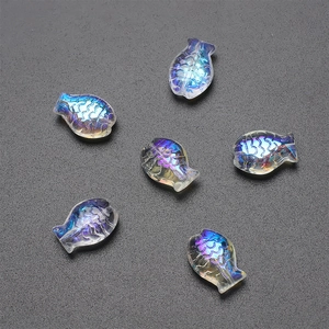 Close-up of fish-shaped iridescent blue crystal beads for DIY jewelry making and crafts