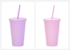 Detail of matte pink and lavender 16oz plastic tumblers with matching lids and straws