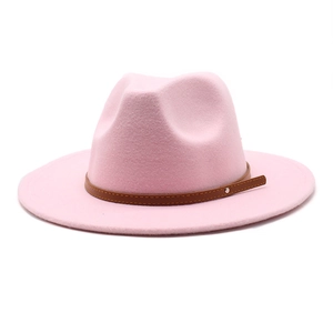 Detailed view of pink wide brim fedora hat featuring a brown faux leather band detail