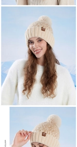 Close-up of winter knit beanie with faux fur pompom and mountain leather patch