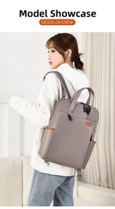 Taupe waterproof backpack on model featuring brown leather trim and large main compartment