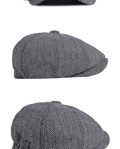 Detailed close-up of grey and black herringbone newsboy cap fabric texture and top button