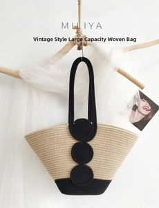 Detail of hand-woven cotton rope tote bag with black spiral accents and beige texture