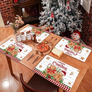 Christmas gingerbread man place mats set of 4 with red plaid border on wooden table