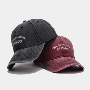 Vintage washed cotton baseball caps with embroidered lettering in dark grey and burgundy