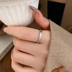 Minimalist silver open rings with colorful star-set zircons worn on index finger