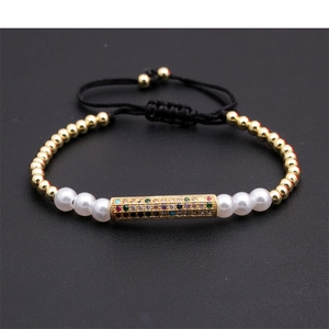 Macro view of woven bracelet with golden beads and colorful zircon pavé detailing