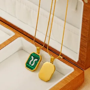 Gold zodiac necklace with green malachite pendant and rhinestones in a white gift box
