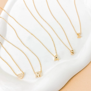 Gold plated hip hop necklaces with zircon inlaid letter and heart pendants on tray