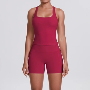 Detail of high-waisted yoga shorts with side pocket in deep rose red stretch fabric