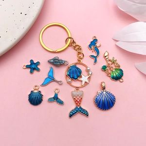 Detailed set of 12 ocean themed enamel pendants with mermaid tails shells and sea stars