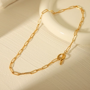 Close-up of gold stainless steel paperclip chain necklace with elegant OT toggle clasp