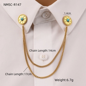 Detail of gold double chain collar pin with turquoise studs on a white shirt collar