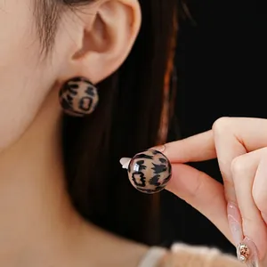 Fashionable leopard print round stud earrings with a glossy minimalist finish