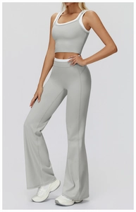 Detail of grey yoga set featuring layered sports bra and high-waisted flared leggings