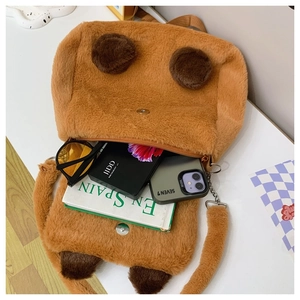 Detail view showing spacious interior capacity of the plush Capybara bag with daily items