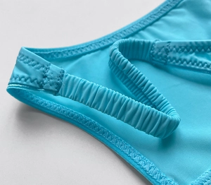 Detailed view of stitching and vibrant blue ice silk fabric for sexy thong bikini