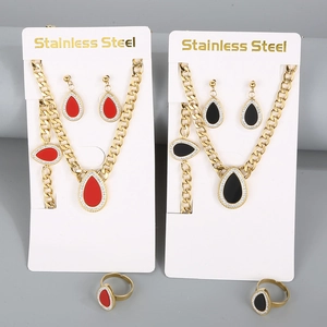 Close-up of gold stainless steel jewelry sets featuring red and black teardrop shell pendants