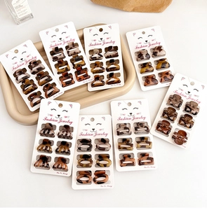 Detailed set of 6 mini leopard tortoise hair claws on packaging cards for styling