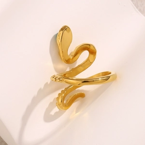 Detailed macro view of 18K gold plated snake ring with sparkling green gemstone eyes