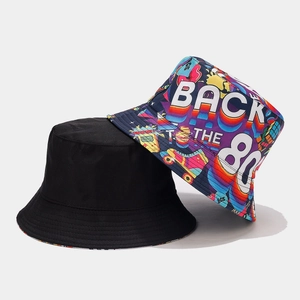 Detail of reversible bucket hat featuring 80s retro graffiti print and black cotton fabric