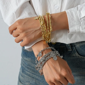 Five-piece layered metal bangle set with coin charms and portrait coins for women
