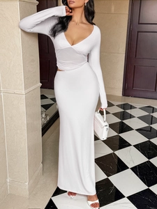 Slim fit white maxi dress with long sleeves, deep V-neck and stylish waist cut-out detail