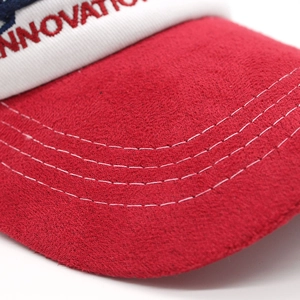 Detailed close-up of red baseball cap brim with white panels and innovation embroidery