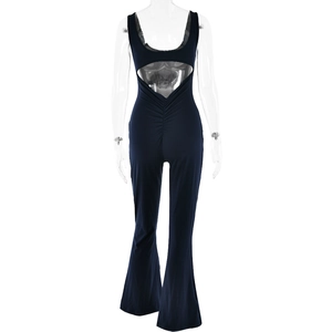 Back view of a tight dark blue backless bodysuit with flared leggings on a mannequin
