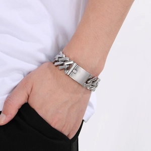 Macro shot of silver Cuban link bracelet featuring a polished rectangle blank metal plate